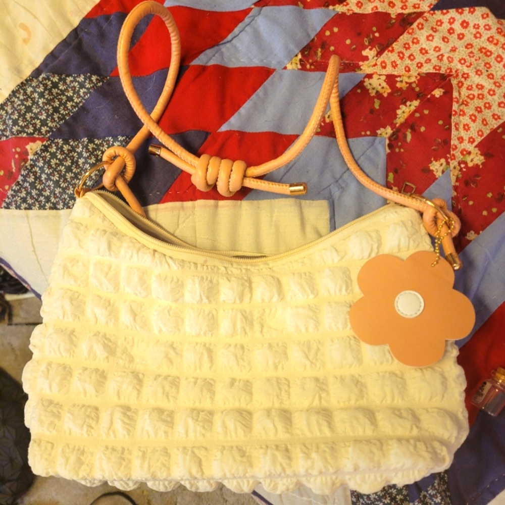 White over one shoulder purse with pink Flower accessory